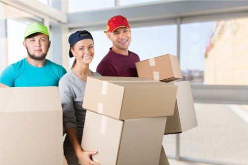 Van moving team following safe lifting procedures during a home removal