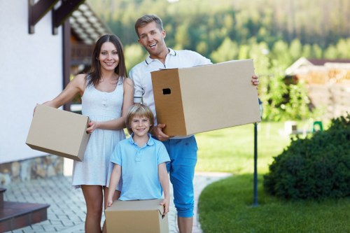 Moving crew handling furniture and boxes during an Elmpark relocation