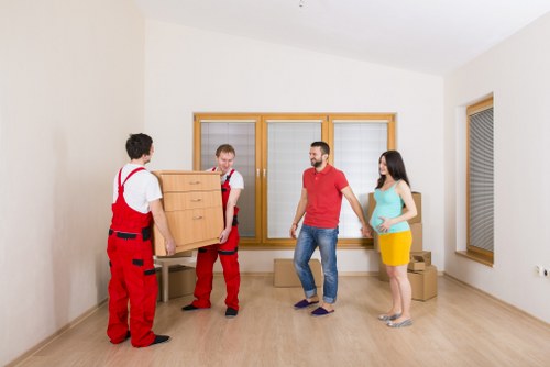 Team packing furniture and boxes into a removal van